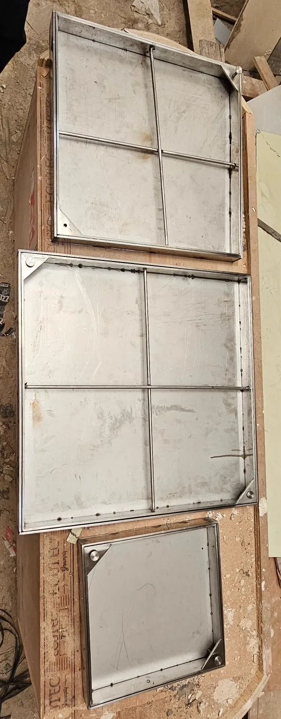 Welded stainless steel support bars inside oversized chamber cover trays